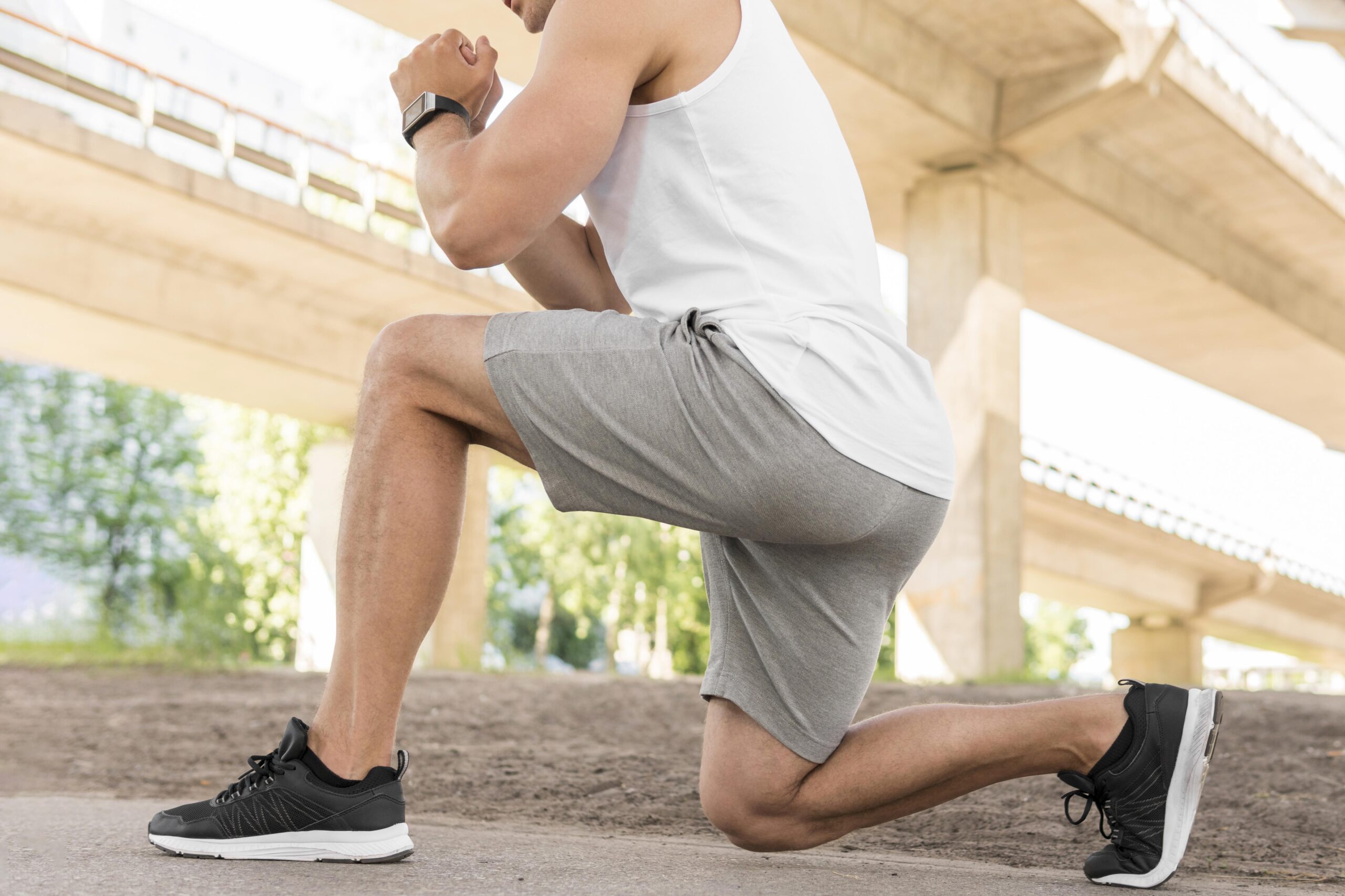 side-view-athletic-man-stretching-outside-scaled